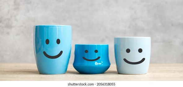 World Smile Day And International Coffee Day Concept. Happy Face Of Blue Coffee Cup For Customer Review. Service Rating, Ranking, Satisfaction And Feedback