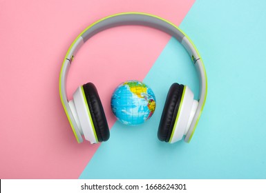 World Song. Global Music Chart. The Music Of Earth. Stereo Headphones And A Globe On A Blue-pink Pastel Background. Top View