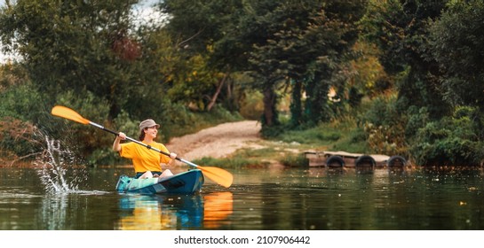 World Tourism Day banner. Happy caucasian woman floating with splashes in kayak at river. Copy space. The concept of kayaking and summer activity.