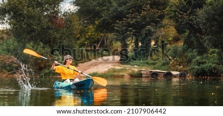 World Tourism Day banner. Happy caucasian woman floating with splashes in kayak at river. Copy space. The concept of kayaking and summer activity.