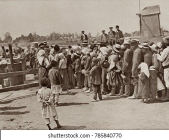 World War 1 In Eastern Europe. Peasants In Retreat From Warsaw Wait For A Meal At A Food Depot Established By The Russians. 1914-15.