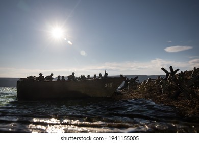 World War 2 reenactment (D-day). Creative decoration with toy soldiers, landing crafts and hedgehogs. Battle scene of Normandy landing on June 6, 1944. Selective focus - Shutterstock ID 1941155005