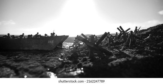 World War 2 reenactment (D-day). Creative decoration with toy soldiers, landing crafts and hedgehogs. Battle scene of Normandy landing on June 6, 1944. Selective focus - Shutterstock ID 2162247789