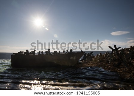 World War 2 reenactment (D-day). Creative decoration with toy soldiers, landing crafts and hedgehogs. Battle scene of Normandy landing on June 6, 1944. Selective focus