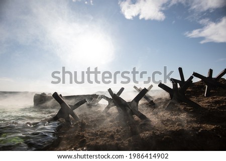 World War 2 reenactment (D-day). Creative decoration with toy soldiers, landing crafts and hedgehogs. Battle scene of Normandy landing on June 6, 1944. Selective focus