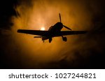 World war ii fighter plane at sunset or dark orange fire explosion sky. War scene. German figher at sky. Selective focus
