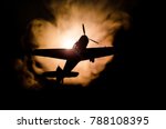 World war ii fighter plane at sunset or dark orange fire explosion sky. War scene. German figher at sky. Selective focus