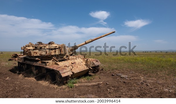 A World War II\
tank left on the battlefield, Golan Heights, Israel. Old rusty tank\
in peacetime. No more war.