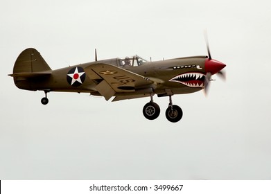 A World War Two P-40 Airplane Landing At An Air Show.