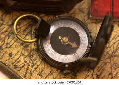 A World War I (WWI) Compass Sitting On A Map.