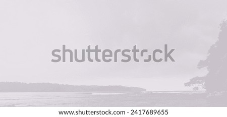 A world without color. Blurry black and white background of beach, elongated hills, sea water, tropical forest, cloudy sky. Blurred beach photos suitable for backgrounds, banners and wallpapers.