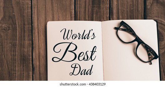 Worlds best dad message written on notebook on table - Powered by Shutterstock