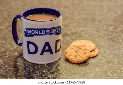 Worlds Best Dad Mug On The Kitchen Side With Biscuits And Tea Bags