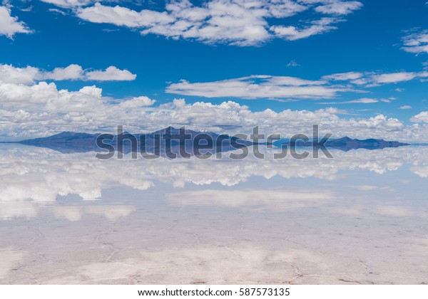 In the world\'s biggest salt desert the ground at\
certain times of the year resembles a giant mirror and the line,\
which divides the sky, and the land is barely discernible - Uyuni,\
Southwest Bolivia