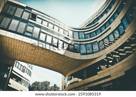 Worm's Eye View of Brown and Black Building Bridge Under Blue and White Cloudy Sky