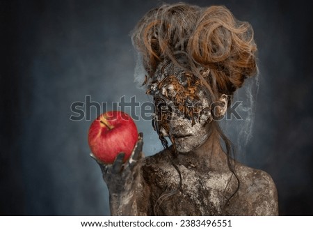 Worms on the face. Worm body. Rotten man. Monster. Halloween. Scary tale. Evil cleaver. Scary fairy. Dark night. Girl with fantasy body art. Apple in hand.