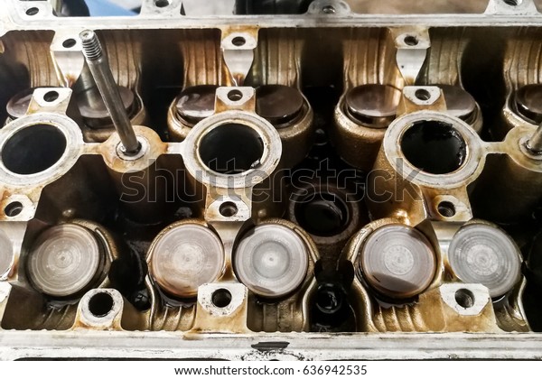 Worn auto car engine valves being serviced and\
repair at garage