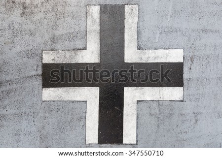 Worn black and white german cross from world war II on an old tank