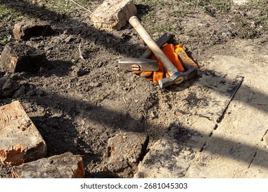 Worn Brick Path with Hammer, Pickaxe and Work Gloves on Ground