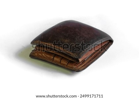 Worn brown leather wallet. Closed up leather wallet on white background