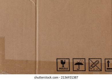 Worn Cardboard Texture With Clear Tape And Safety Symbols