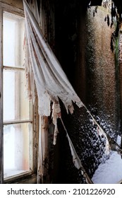 Worn Curtains In Old, Forgotten Farm House In Southern Finland. Snow Inside The House. 