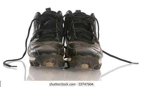 Worn Dirty Football Cleats With Reflection On White Background