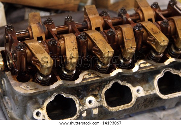 Worn\
dirty gasoline engine on the bench being\
repaired
