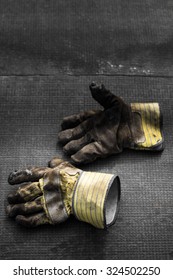 Worn, Dirty Work Gloves On The Floor