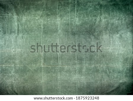 Worn and distressed army surplus green canvas tarp background
