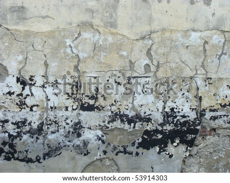 worn gray black painted wall with paint chip crack and blathering