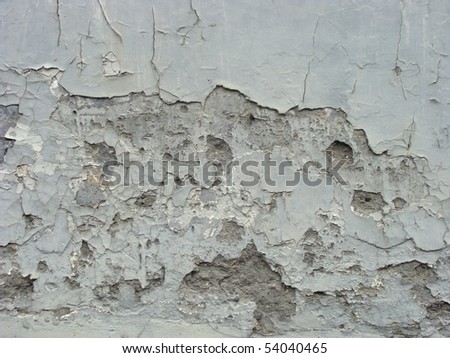 worn gray blue painted wall with paint chip crack and blathering