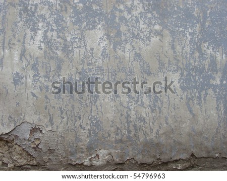 worn gray  painted wall with damage and blathering