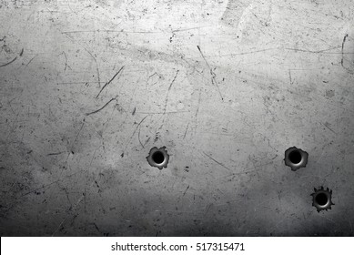 Worn metal background with bullet holes