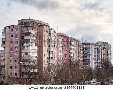 Worn out apartment building from the communist era against blue sky in Bucharest Romania. Ugly traditional communist housing ensemble