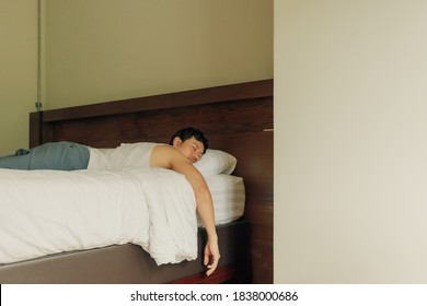 Worn Out Asian Man Sleep On The Bed. Concept Of Exhausted And Tired.