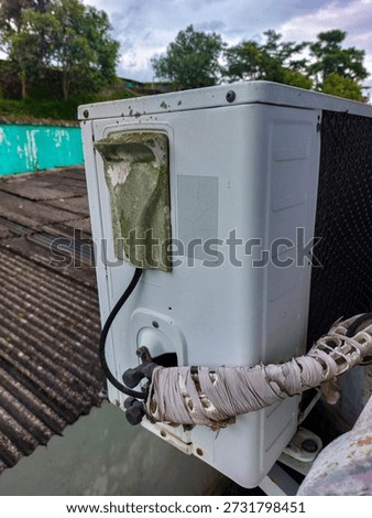 A worn out split air conditioning unit.