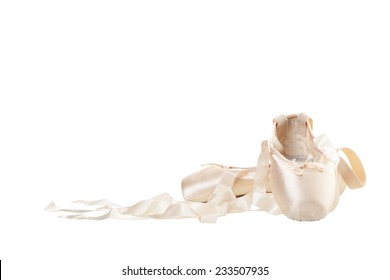 A worn pair of pink Ballet Slippers on white background.