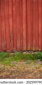 Worn Planks Of A Red Barn Wall.