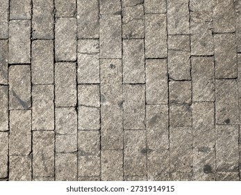 Worn refractory firebrick surface forming an industrial platform floor. Aged heat resistant brick texture suitable for industrial background and construction themes.