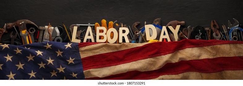 Worn and used collection of work tools with US American flag and Labor Day text. - Shutterstock ID 1807153291