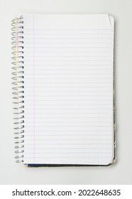 A Worn Used Wire Bound Notebook Opened To A Blank Lined Page