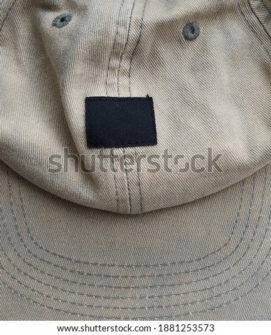 Worn vintage hat cap top view with empty logo label, creative street appeal flyer background texture concept 