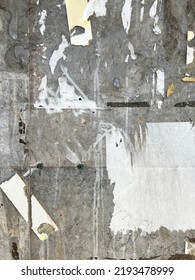 Worn Weathered Grey Urban Concrete Background With Old Sticky Tape And Torn Poster Bits 