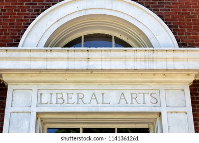 Worn And Weathered Liberal Arts Lettering On Brick Wall.