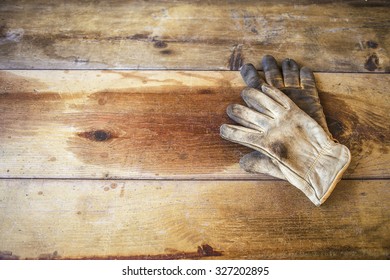 Worn Work Gloves On Vintage Wooden Table, Background With Copy Space