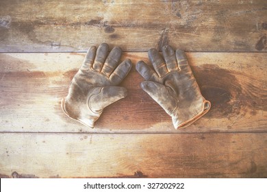 Worn Work Gloves On Vintage Wooden Table, Background With Copy Space, Matte