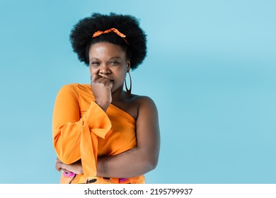 Worried African American Body Positive Woman In Orange Dress Isolated On Blue