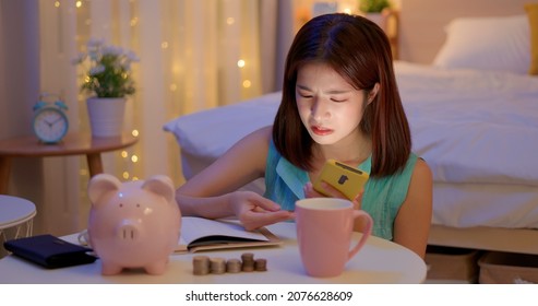 worried asian woman distributing family budget and managing domestic finances in bedroom at home - Shutterstock ID 2076628609