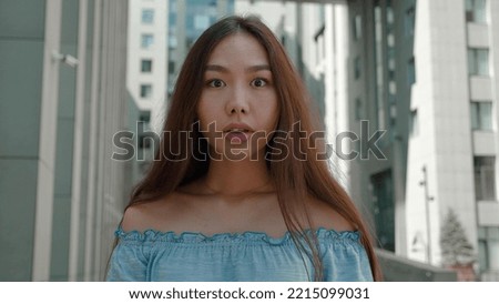 Worried asian woman face looking at camera. Close up of upset thinking about mistakes. Portrait of sad girl. Depressed. I don't understand what you're saying